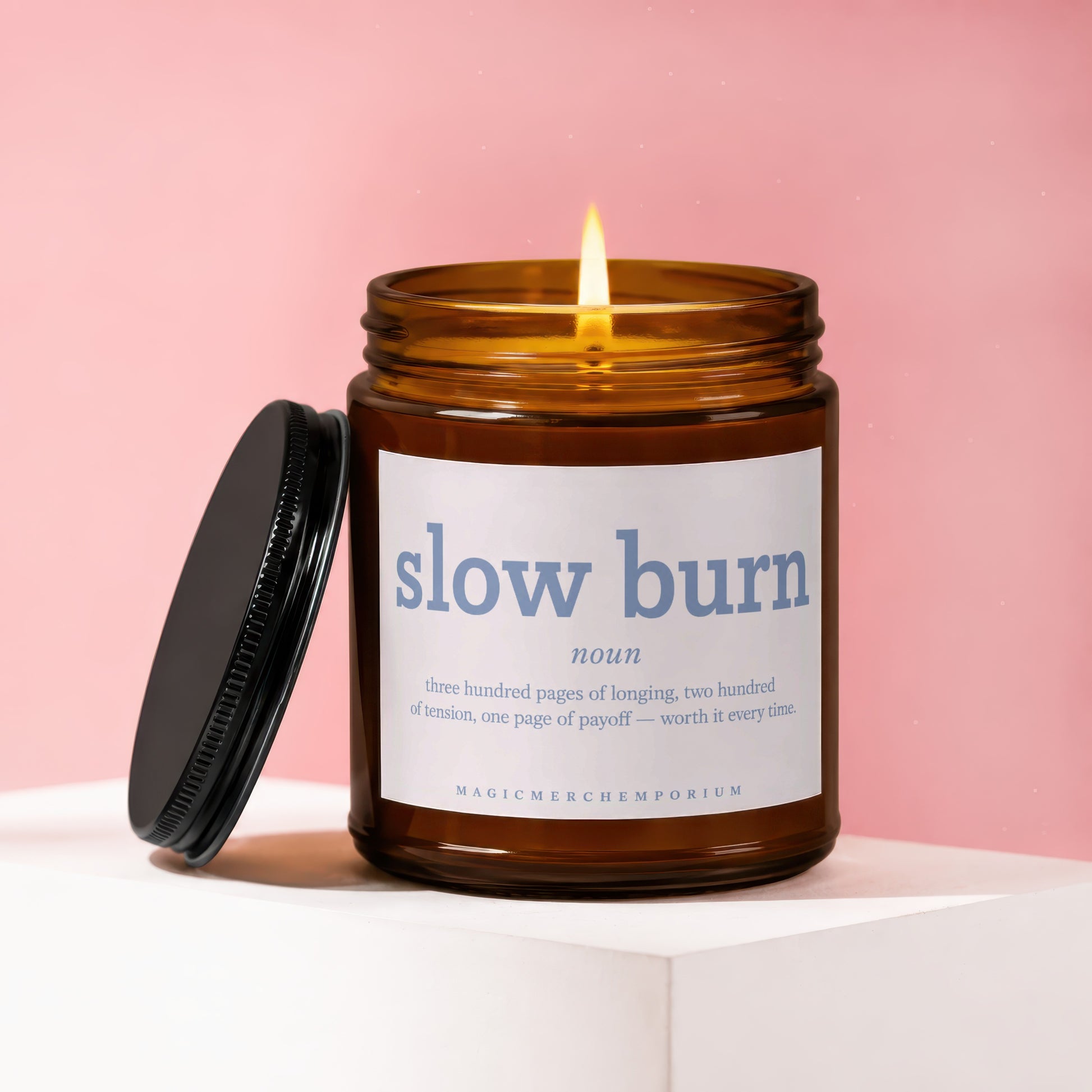 Amber jar candle with lit wick, reads "slow burn" dictionary definition.