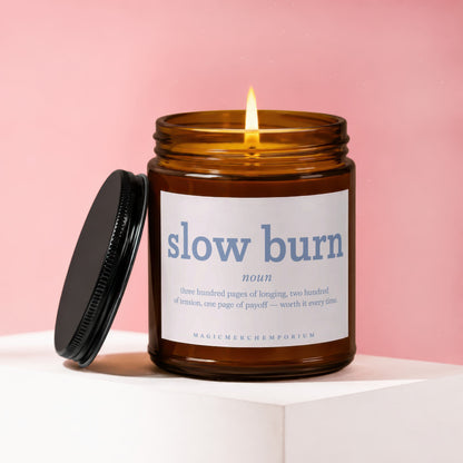 Amber jar candle with lit wick, reads "slow burn" dictionary definition.