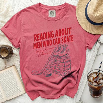 Red t-shirt with "Reading About Men Who Can Skate Hockey Romance Enthusiast" graphic.