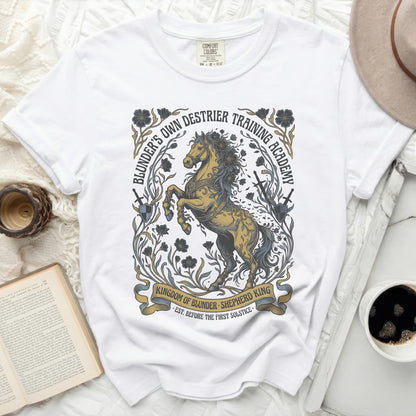 White t-shirt with "Blunder's Own Destrier Training Academy" graphic.