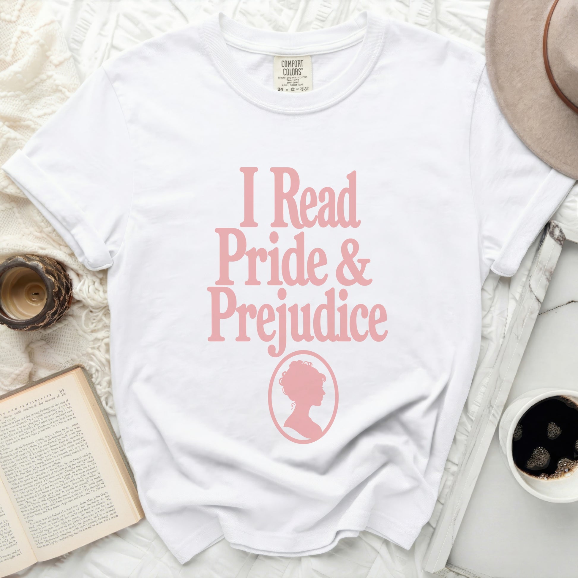 White t-shirt with pink text "I Read Pride & Prejudice" and silhouette.