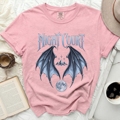 Pink t-shirt with "NIGHT COURT" text and dragon wings, moon, and mountains graphic.