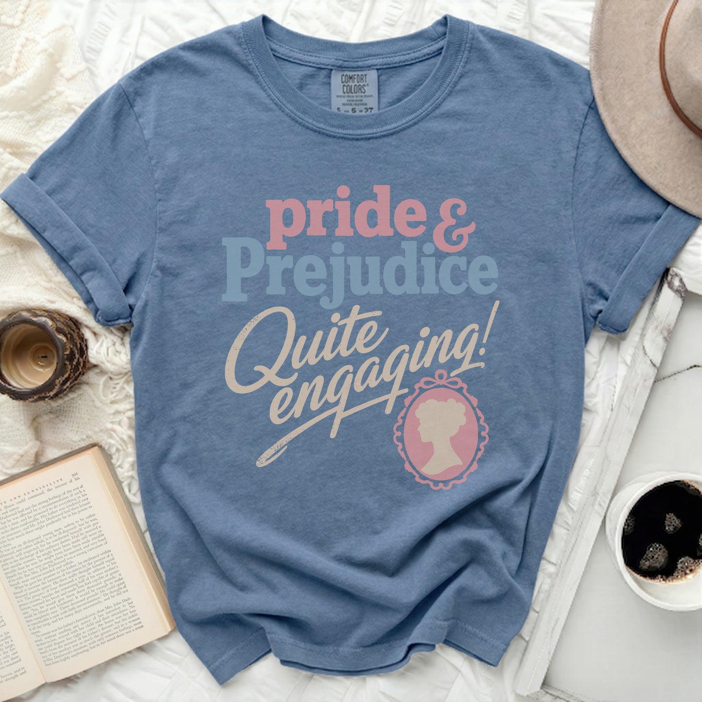 Blue t-shirt with "Pride & Prejudice Quite Engaging!" text.