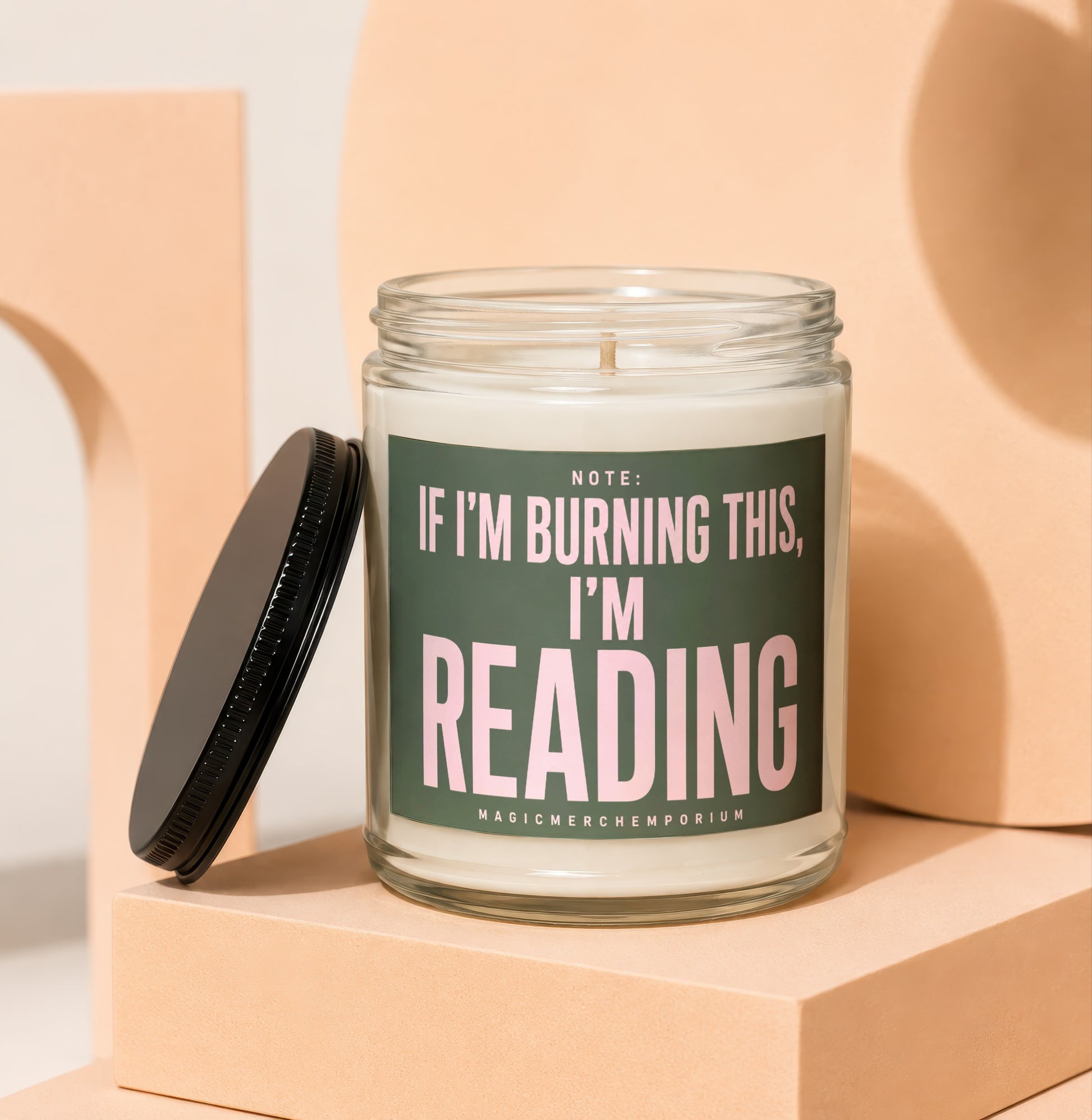 Candle with text "If I'm burning this, I'm reading" on a dark green label