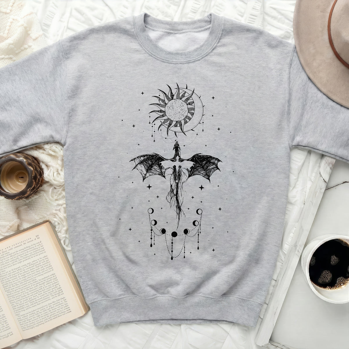 Light gray sweatshirt with black dragon, sun, moon, and phases of the moon graphic.