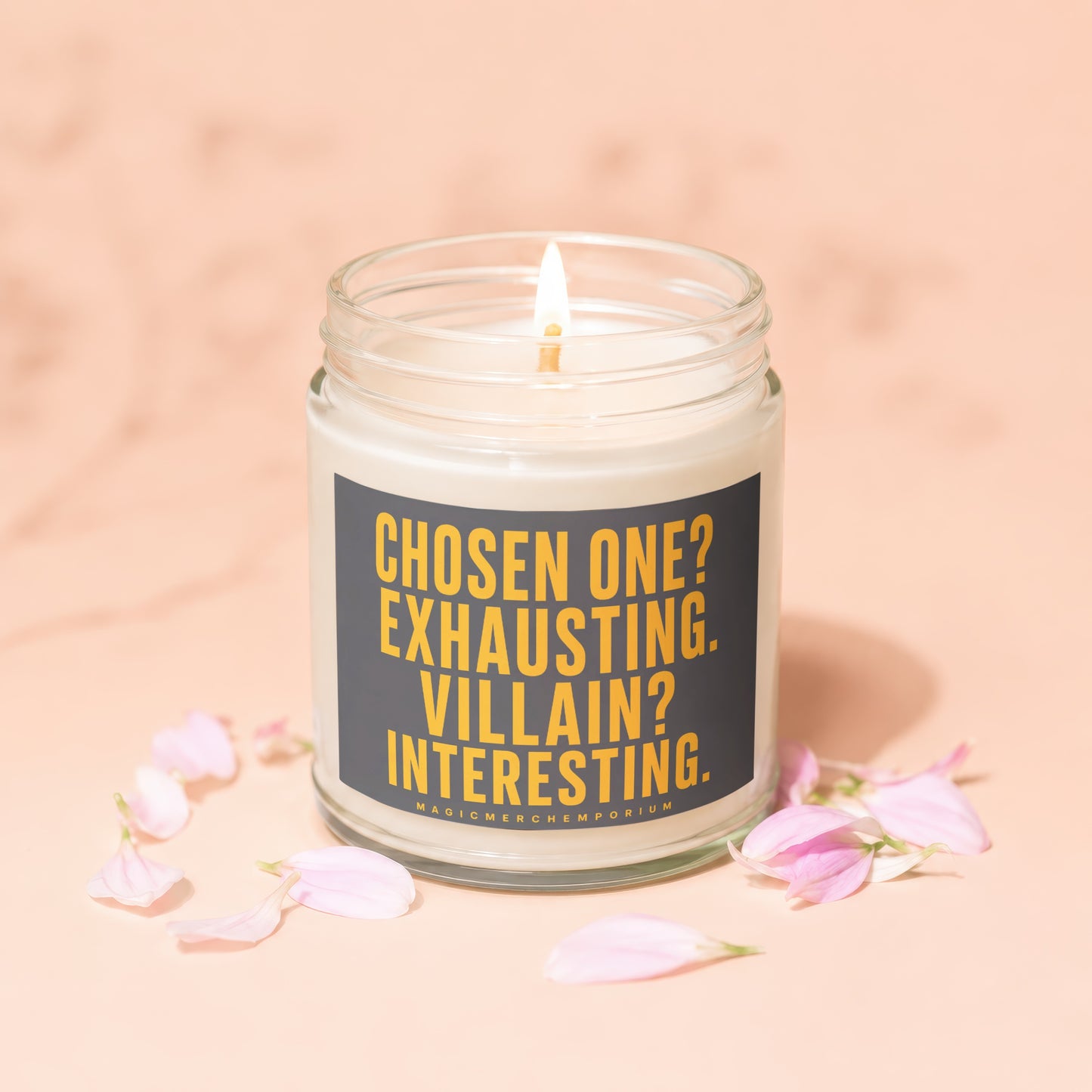 Glass jar candle with burning wick, featuring text "Chosen one? Exhausting. Villain? Interesting."