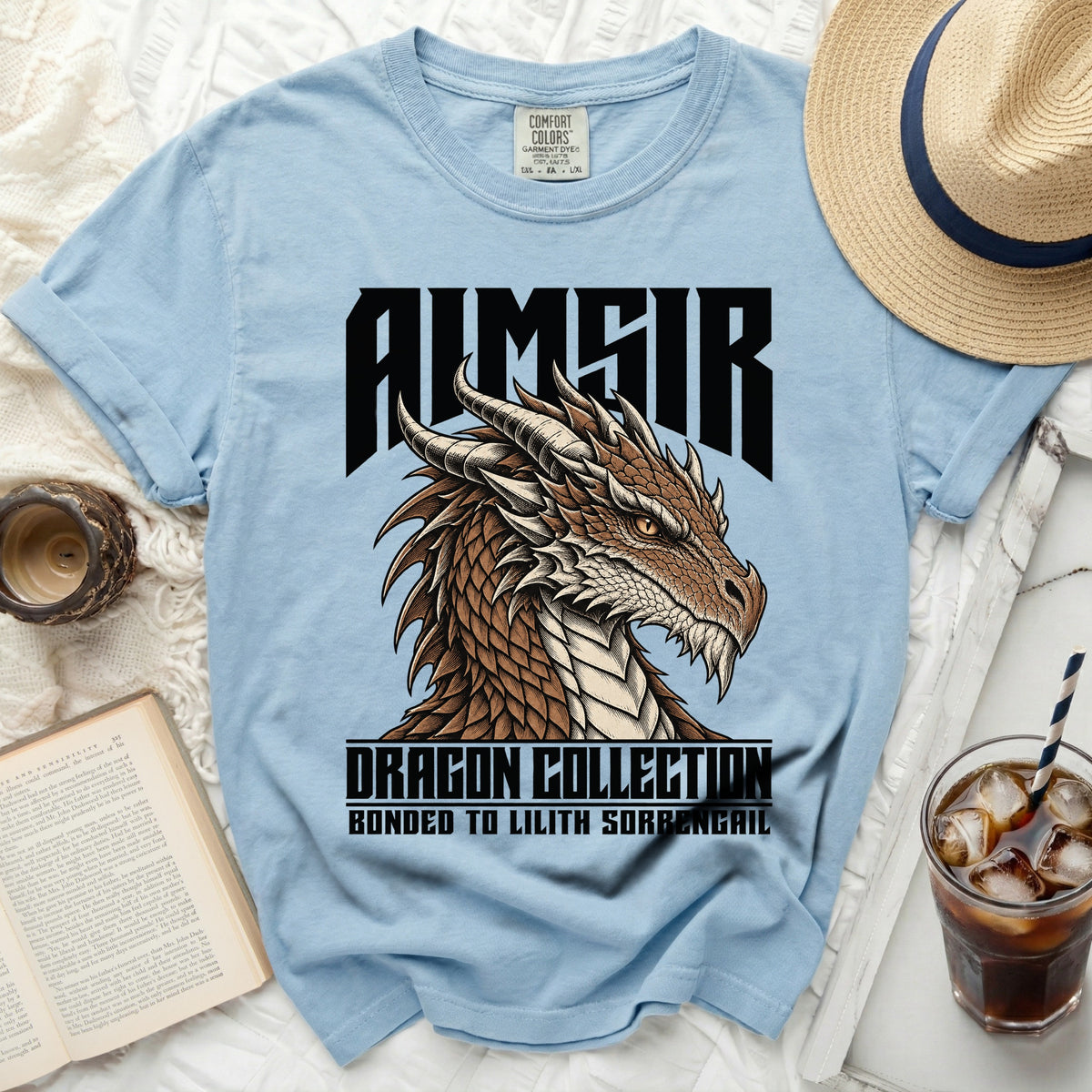 Light blue t-shirt with black text and a detailed dragon head graphic.
