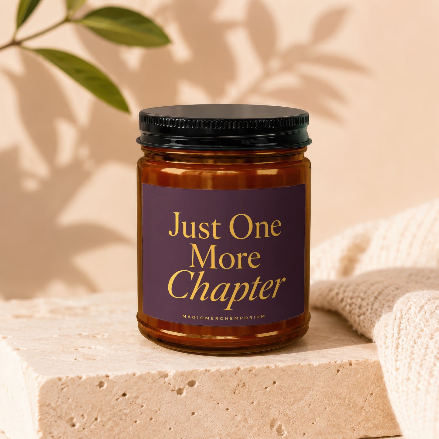 Amber candle with a purple label that reads "Just One More Chapter"