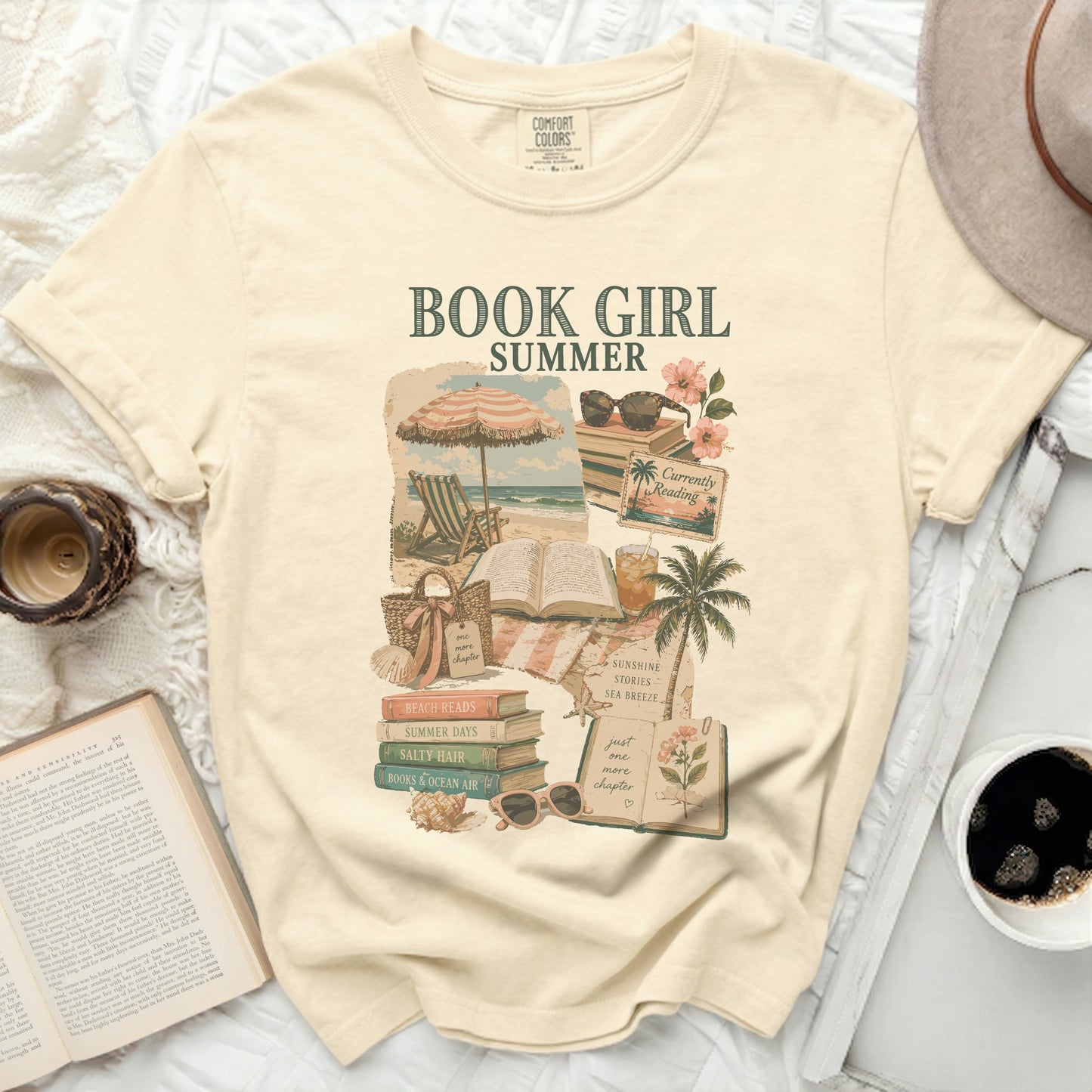 Cream t-shirt with "BOOK GIRL" graphic featuring beach and book elements.