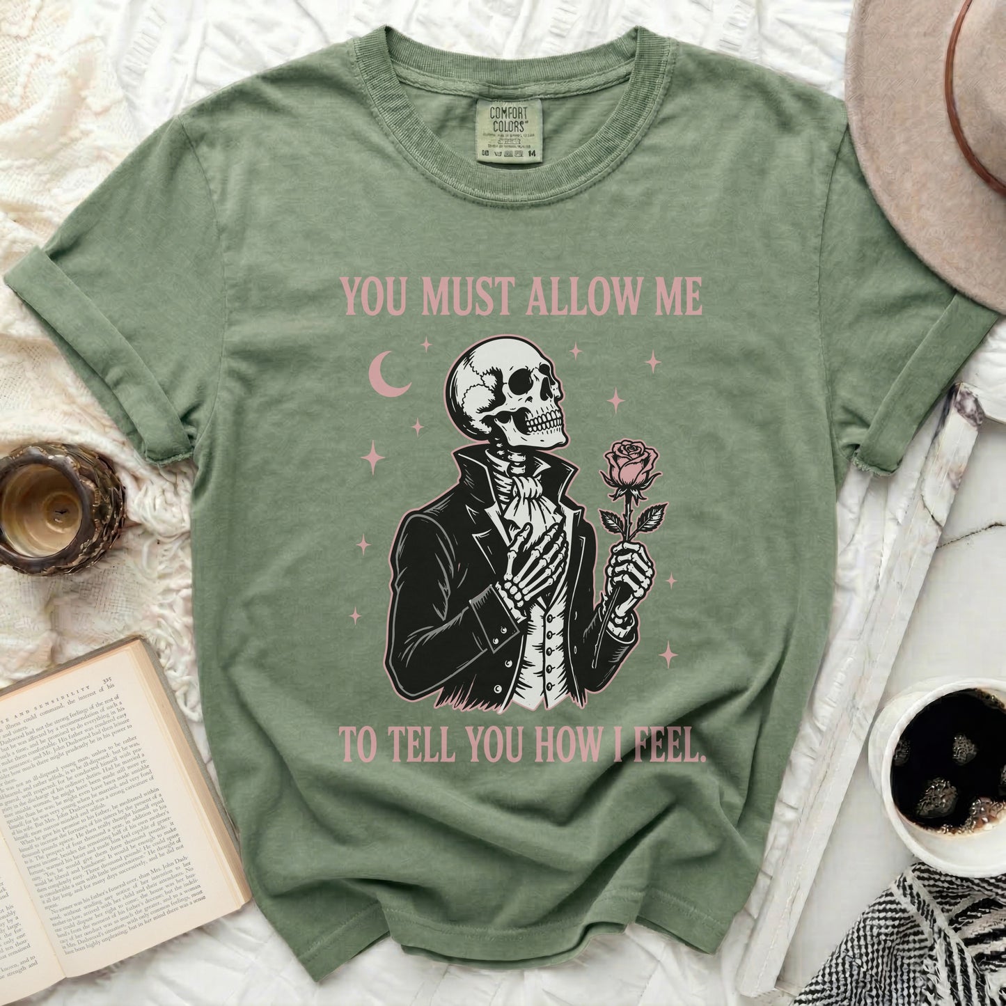 Olive green t-shirt with skeleton holding rose and text "You Must Allow Me To Tell You How I Feel."