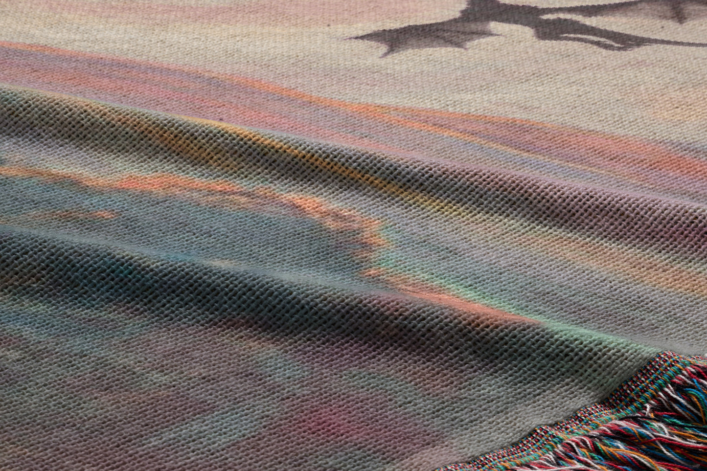 a close-up view of a textured fabric with a dragon design on it. The dragon appears to be in flight, and the fabric has a colorful, abstract pattern.