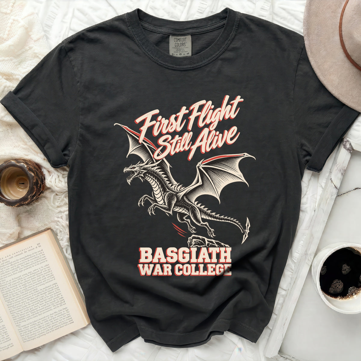Black t-shirt with a dragon graphic and text "First Flight Still Alive Basgiath War College".