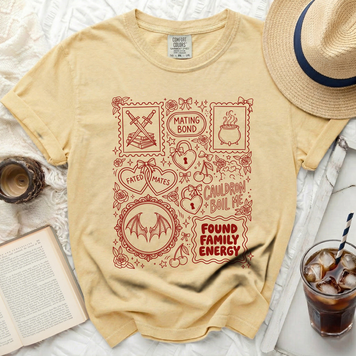 Yellow t-shirt with red line art of witchy symbols, hearts, and text.