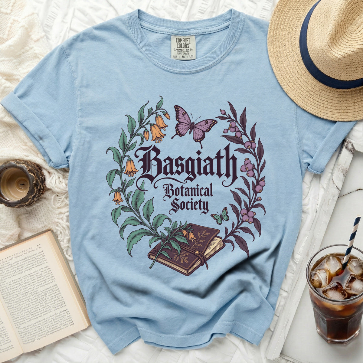 Light blue t-shirt with "Basgiath Botanical Society" text and floral design.