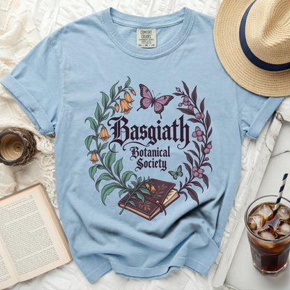 Light blue t-shirt with "Basgiath Botanical Society" text and floral design.