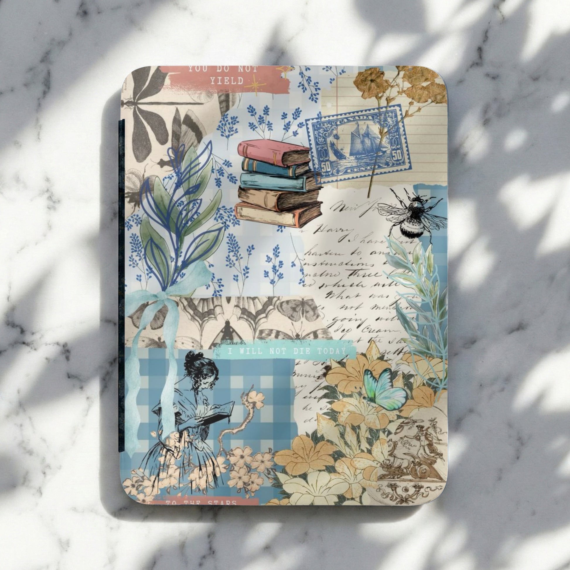Collage journal with vintage stamps, books, floral motifs, and script text.