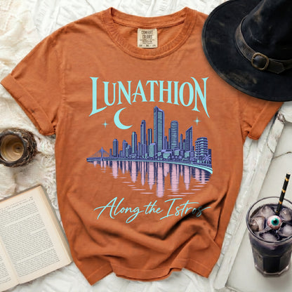 Orange t-shirt with "Lunathion" and a cityscape with moon, "Along the Istros" text.