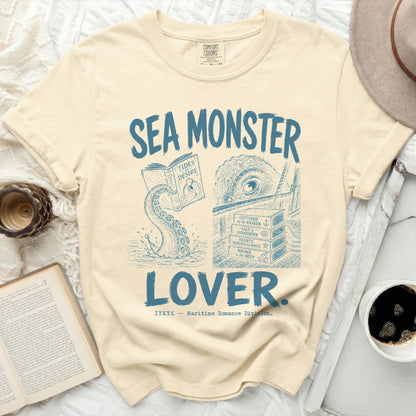 Cream t-shirt with blue "Sea Monster Lover" graphic and book titles.