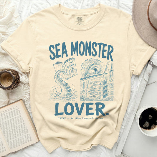 Cream t-shirt with blue "Sea Monster Lover" graphic and book titles.