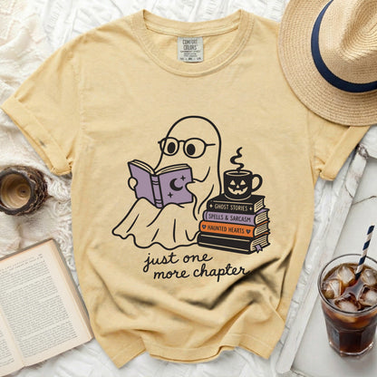 Ghost wearing glasses reading a book, "Just one more chapter" on a yellow shirt.