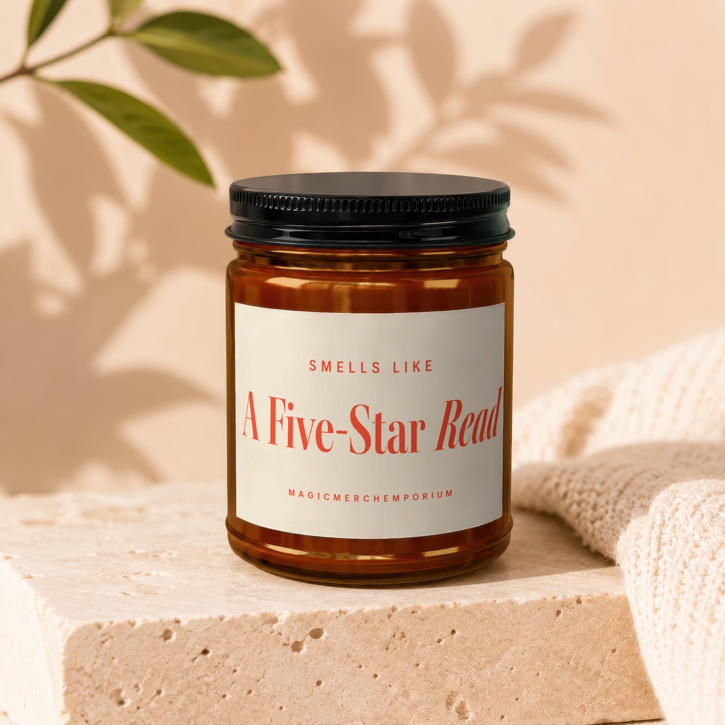 Amber candle in glass jar with black lid, labeled "Smells Like A Five-Star Read".