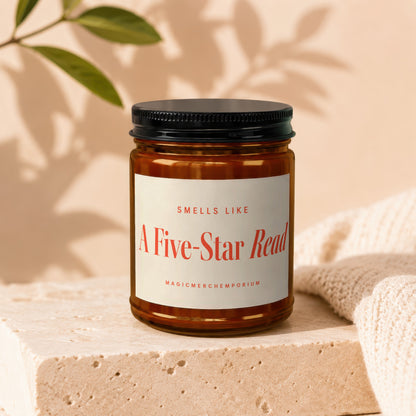 Amber candle in glass jar with black lid, labeled "Smells Like A Five-Star Read".