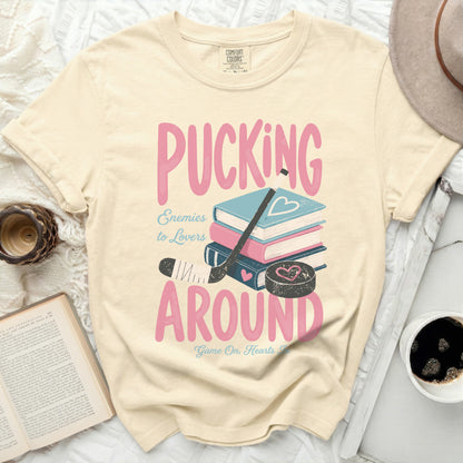 T-shirt with "Pucking Around" text and hockey puck, stick, and puck.