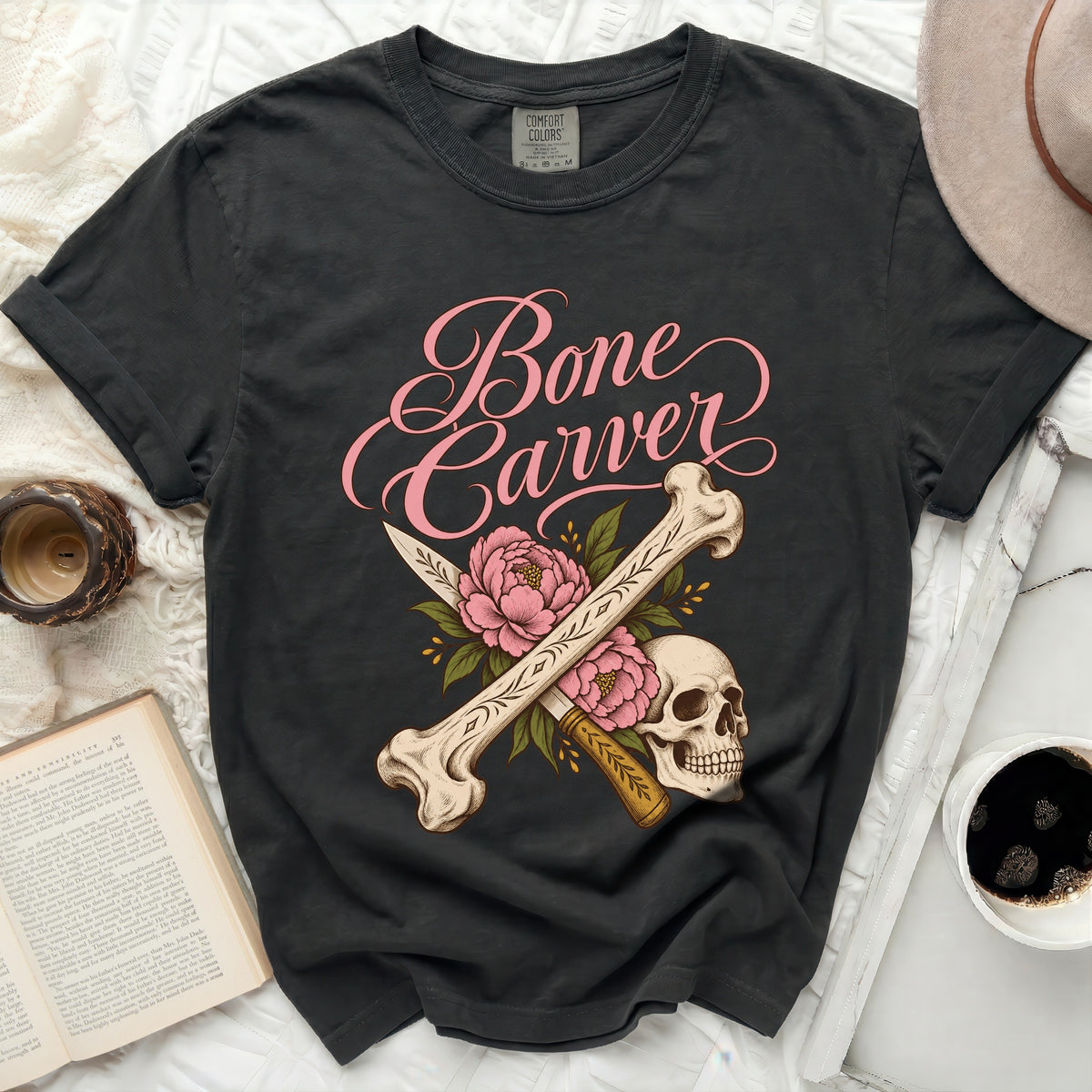 Dark t-shirt with "Bone Carver" text and skull, bone, knife, and flower graphic.