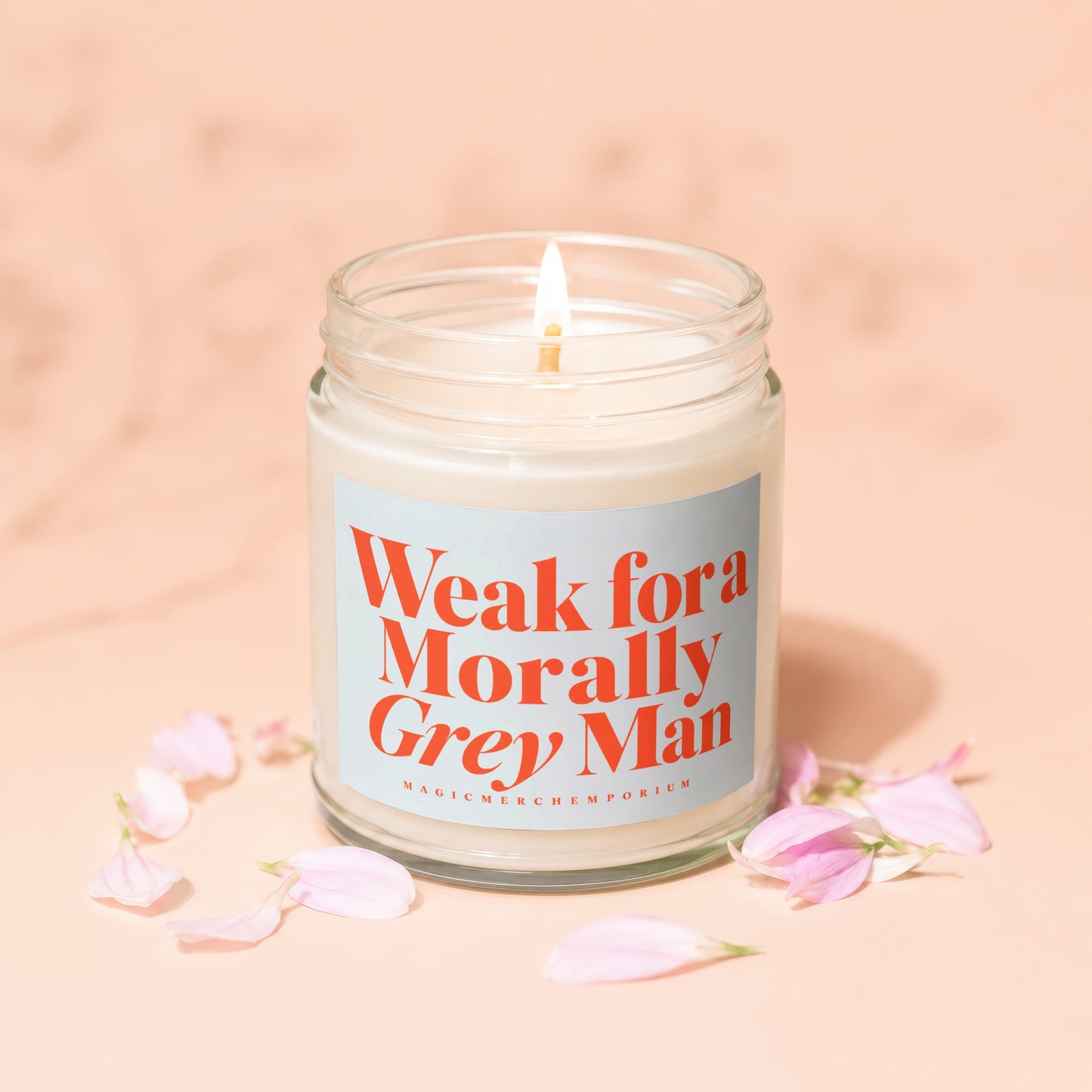 Candle with lit wick, reads "Weak for a Morally Grey Man".