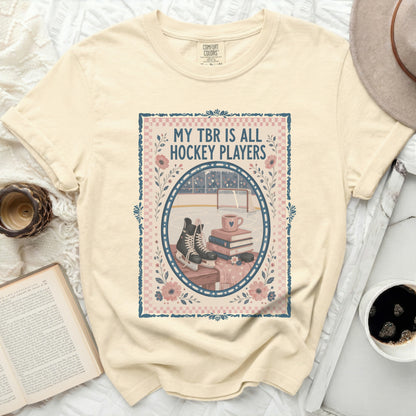 Cream t-shirt with "MY TBR IS ALL HOCKEY PLAYERS" text and hockey rink graphic.
