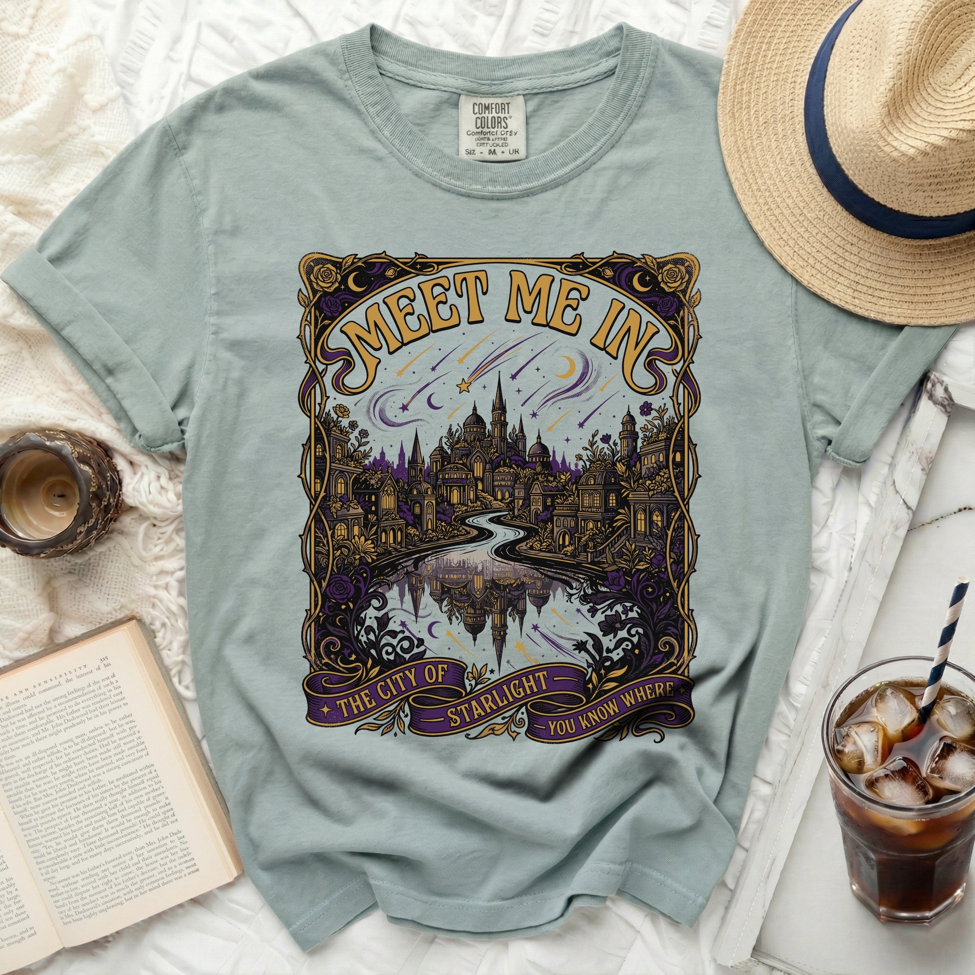 Light blue t-shirt with "Meet Me In The City of Starlight" art.