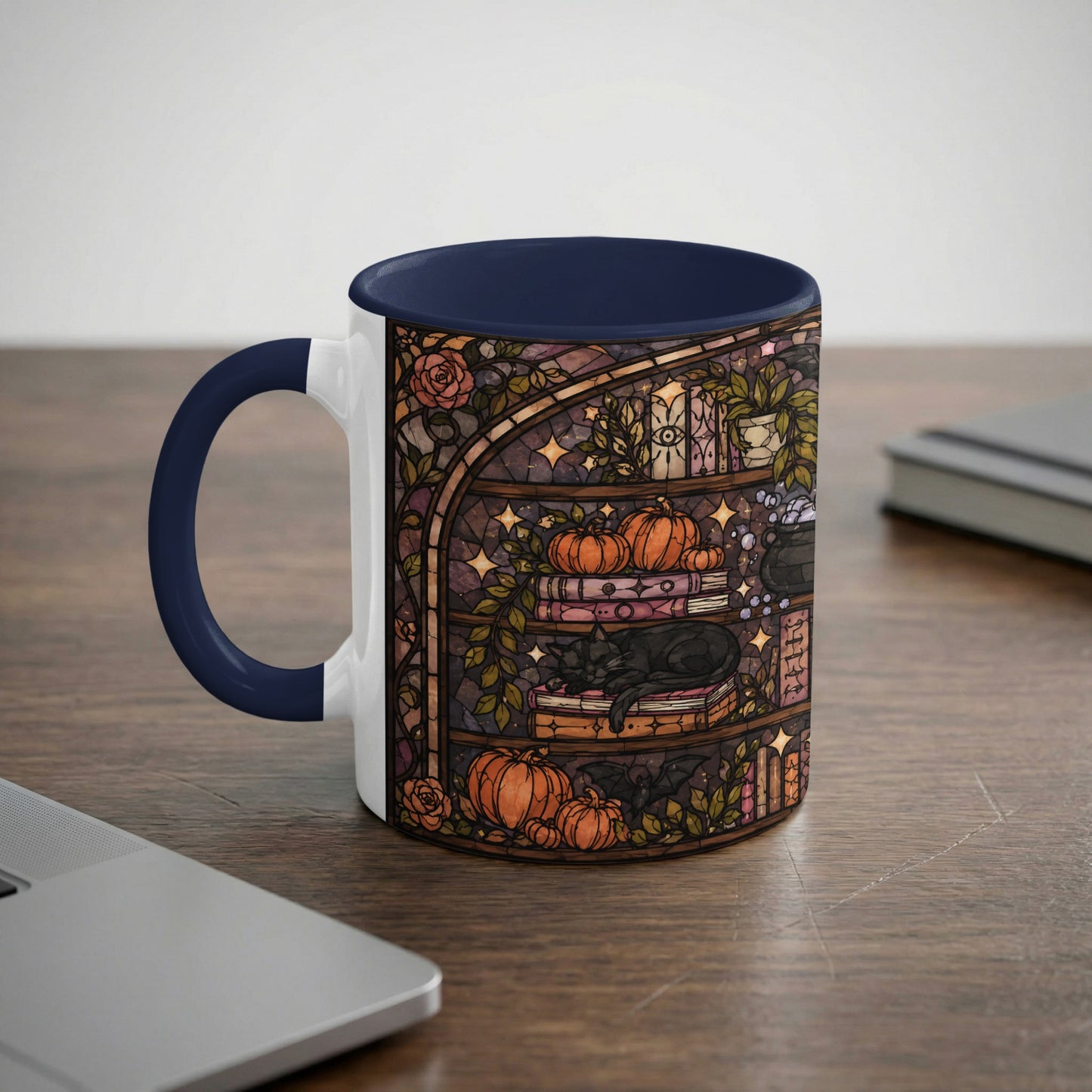 Mug with stained glass art of a black cat sleeping on books, surrounded by pumpkins and a cauldron.