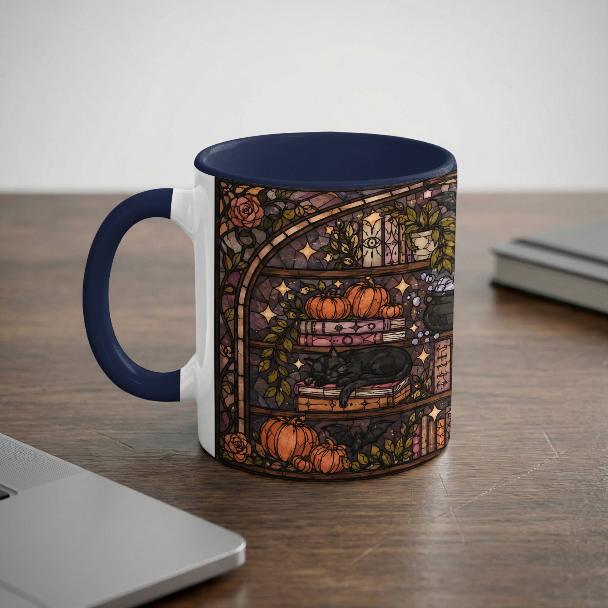 Mug with stained glass art of a black cat sleeping on books, surrounded by pumpkins and a cauldron.