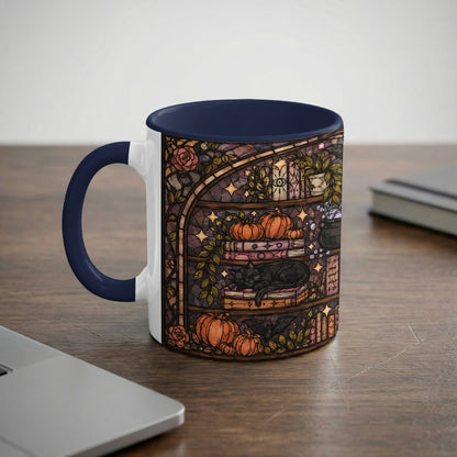 Mug with stained glass art of a black cat sleeping on books, surrounded by pumpkins and a cauldron.