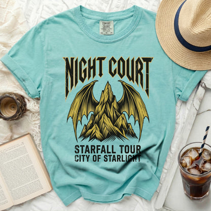 Teal t-shirt with "Night Court Starfall Tour City of Starlight" text and winged mountain graphic.