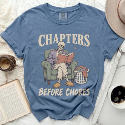 Skeleton reading a book with text "CHAPTERS BEFORE CHORES".