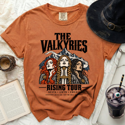 Orange t-shirt with "The Valkyries Rising Tour" featuring three women and a sword.