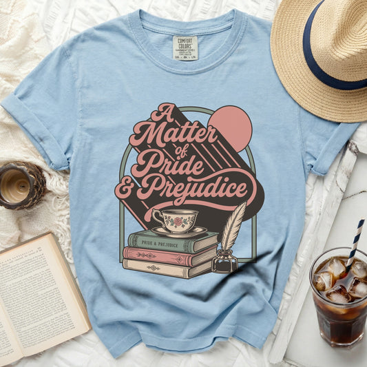 Blue t-shirt with "A Matter of Pride & Prejudice" graphic and books.