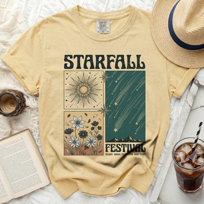 Yellow t-shirt with a "Starfall Festival" graphic featuring sun, stars, flowers, and mountains.