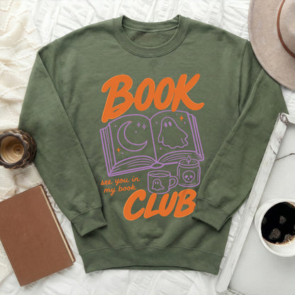 Olive green sweatshirt with "Book Club" graphic featuring ghost and moon.
