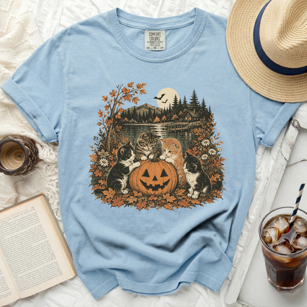 Light blue t-shirt with kittens and jack-o'-lantern on a lake scene.