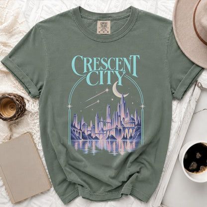 Green t-shirt with "Crescent City" text and fantasy cityscape graphic.