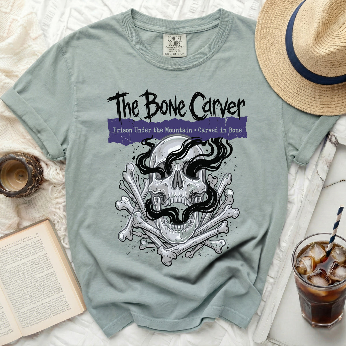 The Bone Carver t-shirt with skull and bones graphic, text "Prison Under the Mountain".