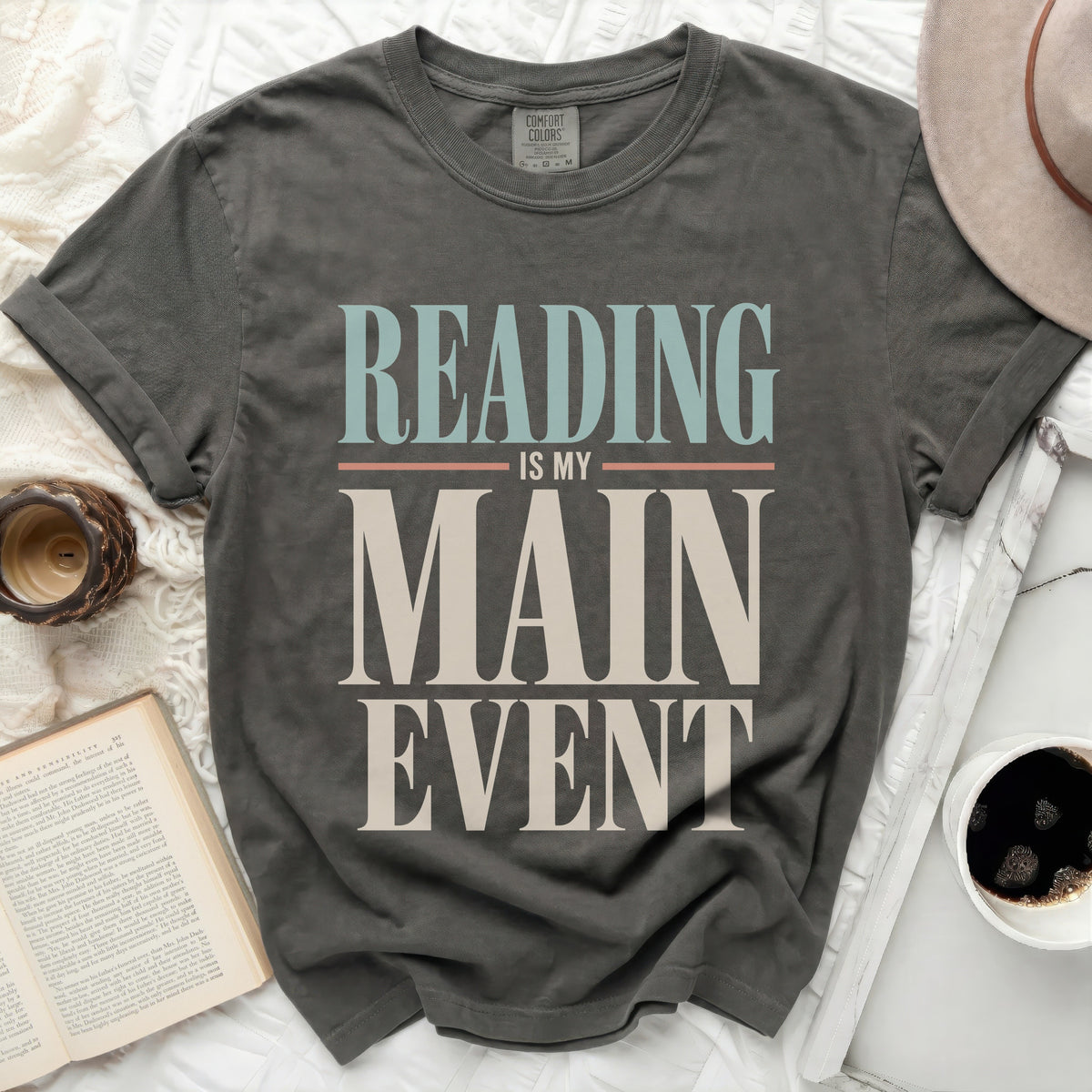 Grey t-shirt with "Reading Is My Main Event" text in vintage style.