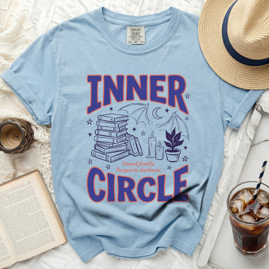 Light blue t-shirt with "INNER CIRCLE" graphic, books, bats, and candles.