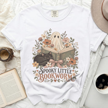 White t-shirt with "Spooky Little Bookworm" graphic featuring a ghost, cat, and flowers.