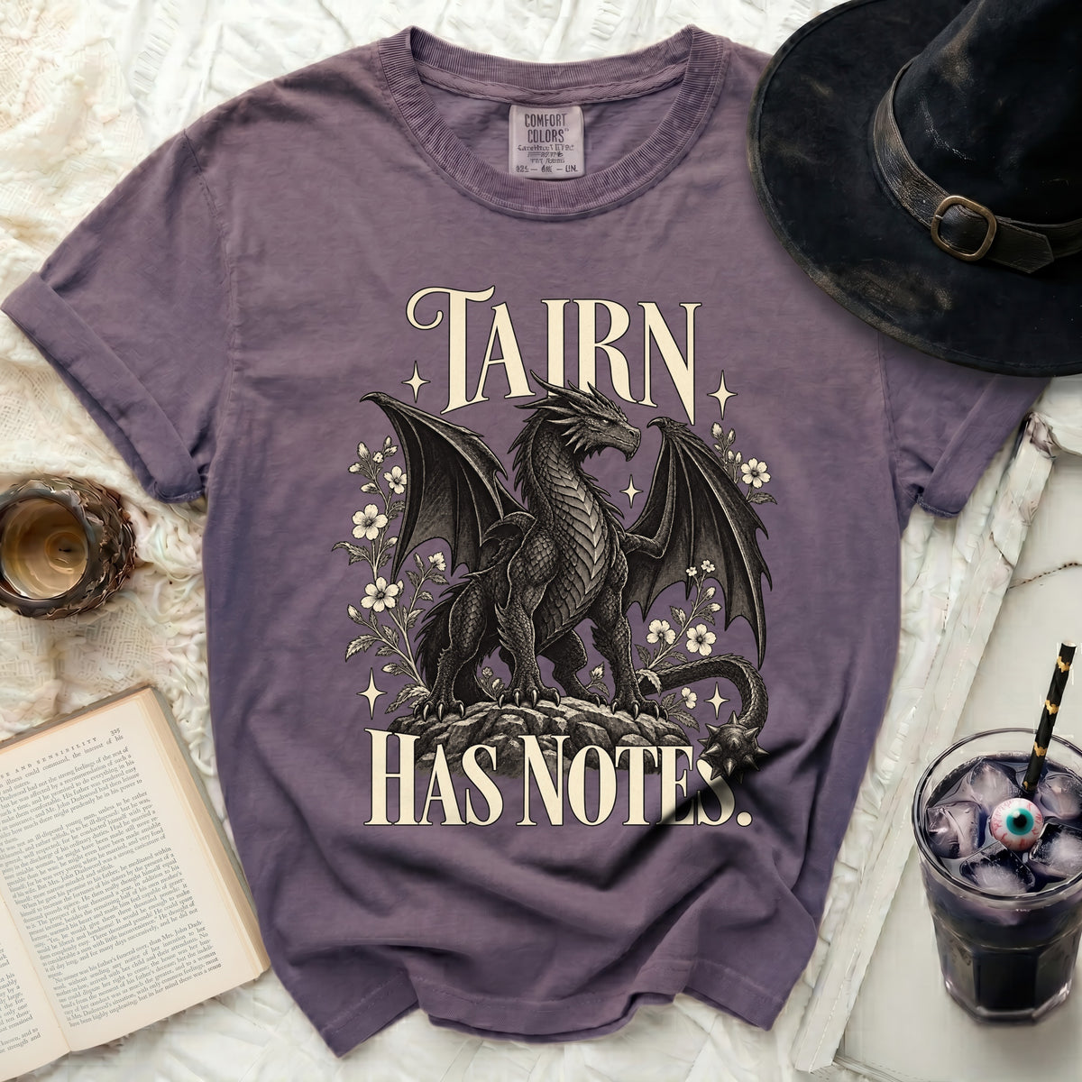 Purple t-shirt with a dragon graphic and text that reads "TAIRN HAS NOTES."