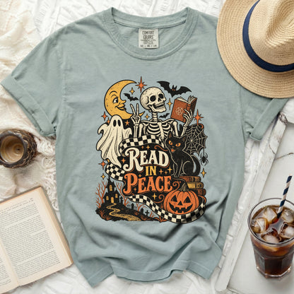 T-shirt graphic with skeleton, ghost, black cat, moon, bats, and "Read in Peace" text.