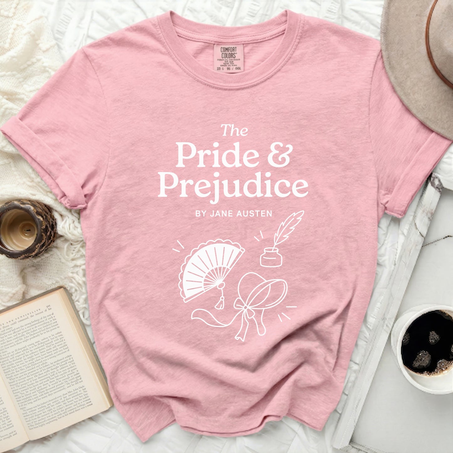 Pink t-shirt with "The Pride & Prejudice by Jane Austen" and bookish illustrations.