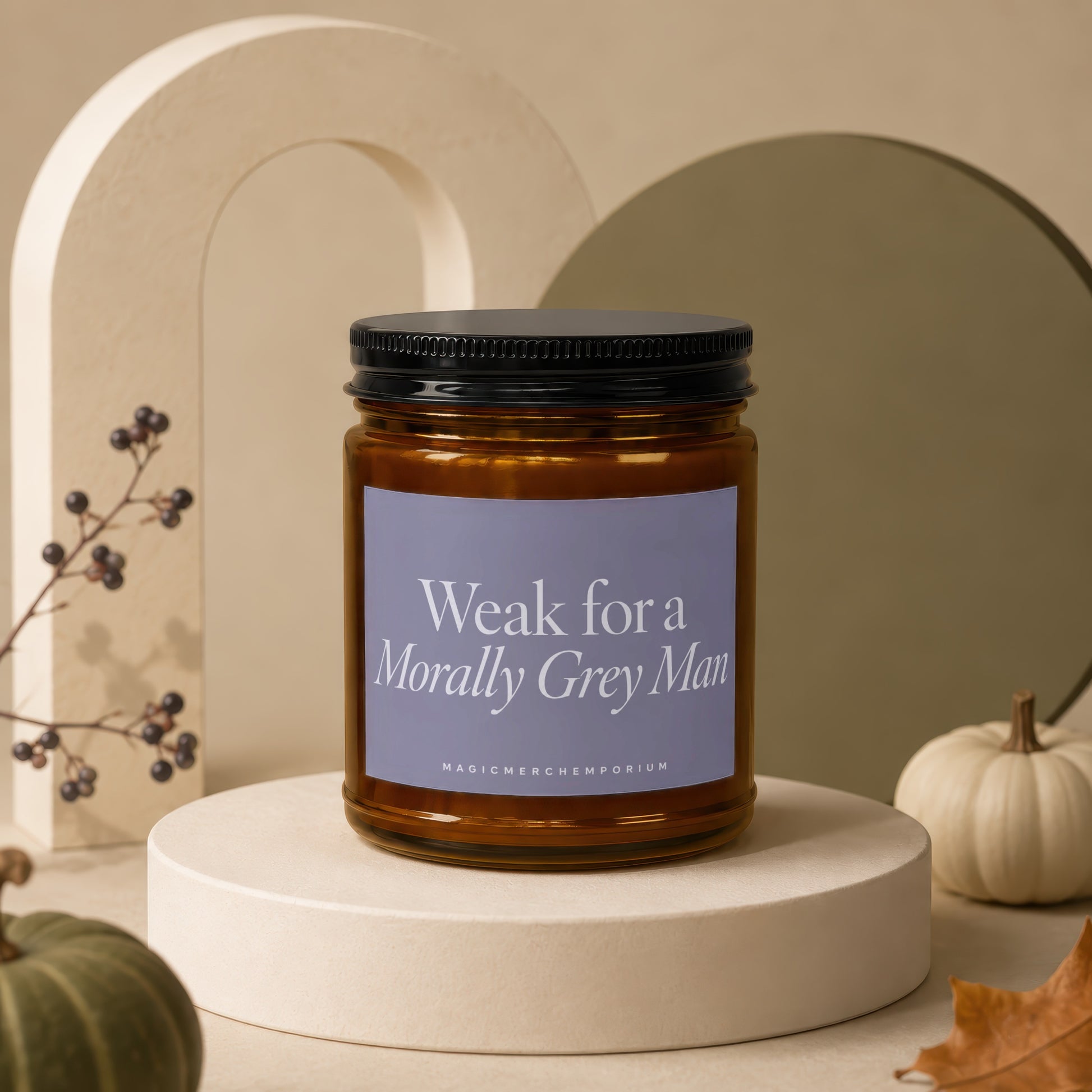Amber jar candle with black lid and label reading "Weak for a Morally Grey Man".